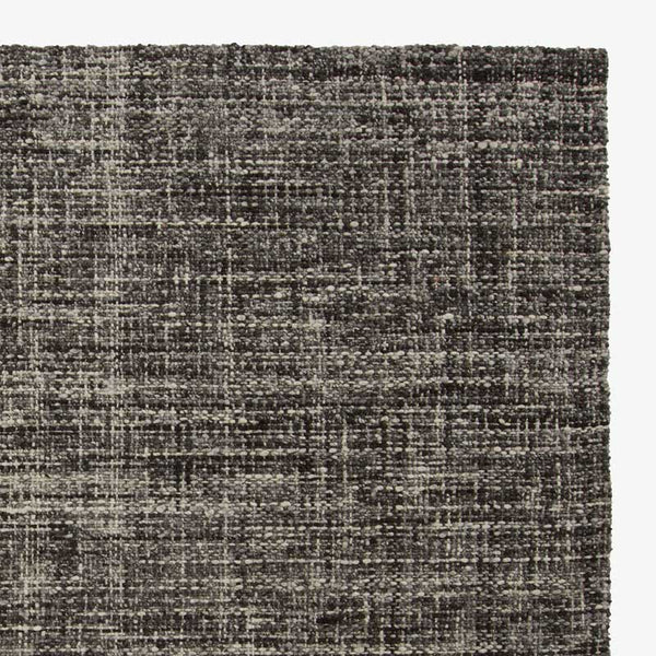 Tissage — zbliżenie splotu tkaniny, struktura materiału w odcieniach szarości